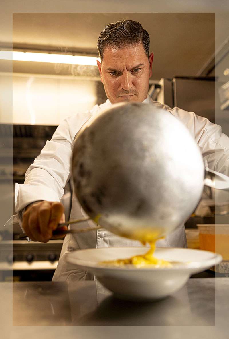 chef pouring carbonara cream